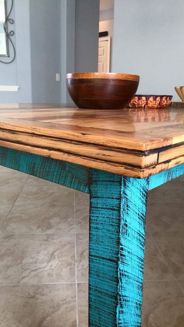 Close-up of the table's wood edge and textured turquoise leg
